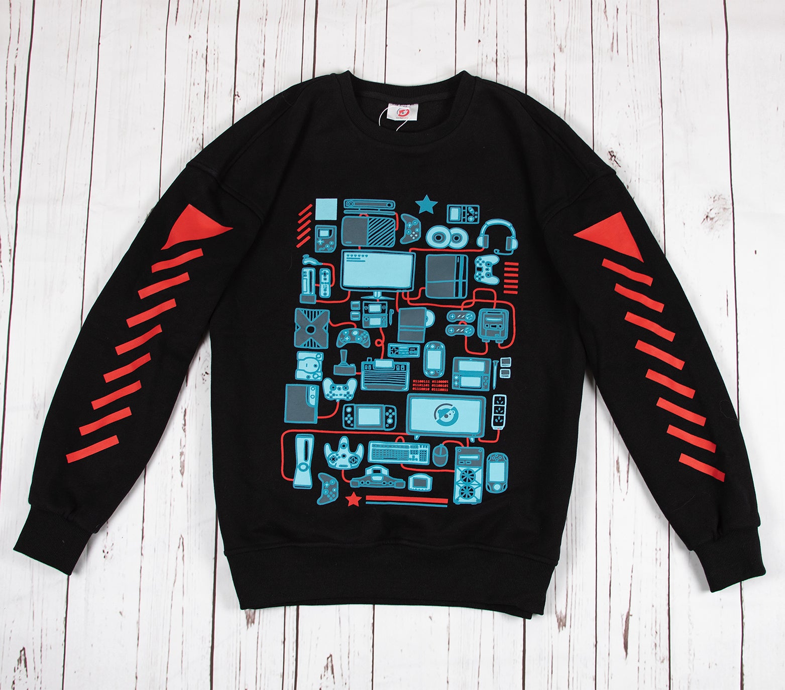 Black sweatshirt with front screen printed design of various console gaming consoles and controllers illustrated in cyan. The front shirt design also features PC gaming as well as mobile gaming devices. The sleeves features slanted red stripes that gives the shirt a streetwear feel. The sweatshirt comes in black with an ultra-soft exterior jersey fabric and a fuzzy soft interior. Sweatshirt comes in XS to 2XL