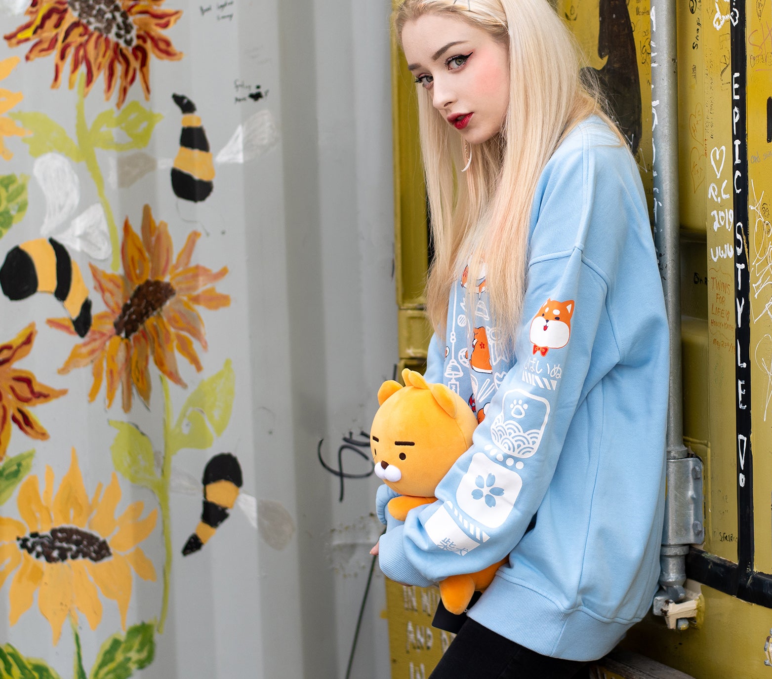 This light blue sweatshirt features a front design of a group of shiba inu in various adorable poses. The design captures the various antics of the shiba inu. Both sleeves also feature designs that run down the sleeves, which matches the front main design of the sweatshirt. The material is medium heavy jersey style with a soft fleece interior. The sweatshirt comes in sizes from XXS to 2XL. 